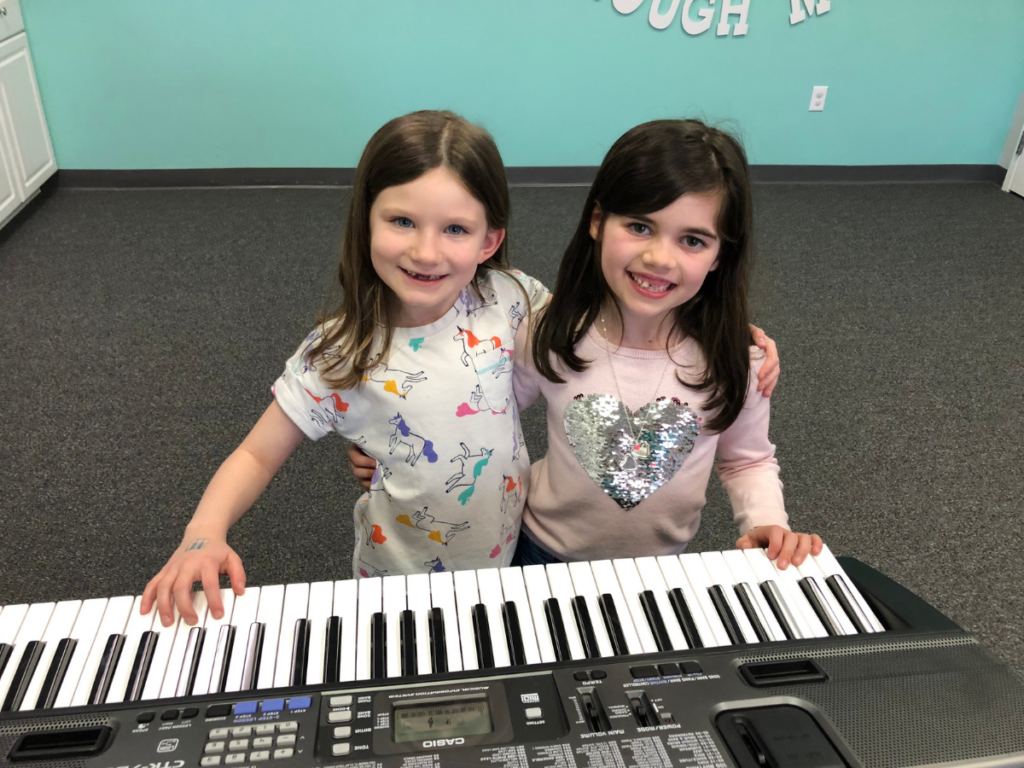 Group Piano students at the keyboard at Melody Magic Music Studio